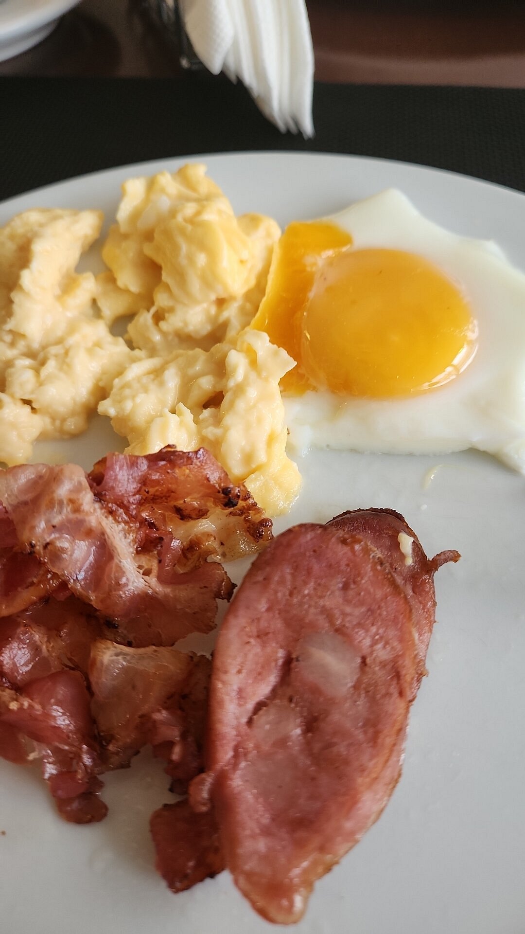 Breakfast plate with eggs, bacon and sausage
